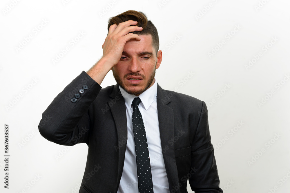 Portrait of handsome bearded Hispanic businessman in suit Portrait of handsome bearded Hispanic businessman in suit