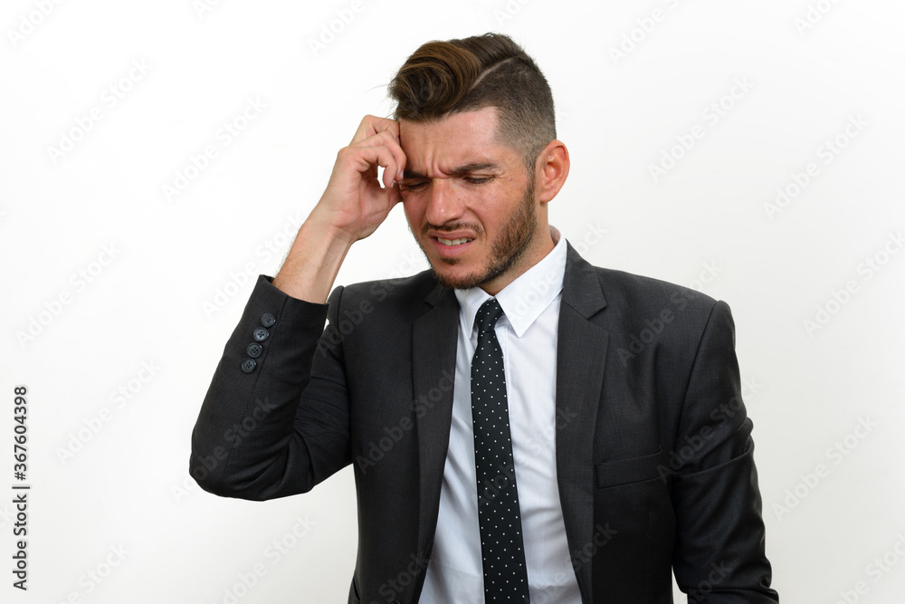Portrait of handsome bearded Hispanic businessman in suit Portrait of handsome bearded Hispanic businessman in suit