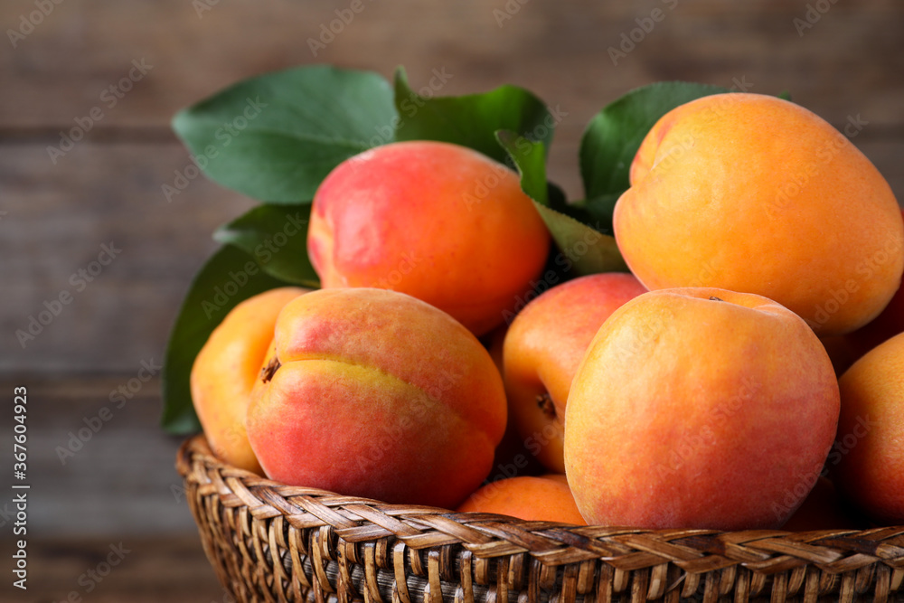 Delicious fresh ripe apricots on wooden background, closeup Delicious fresh ripe apricots on wooden background, closeup