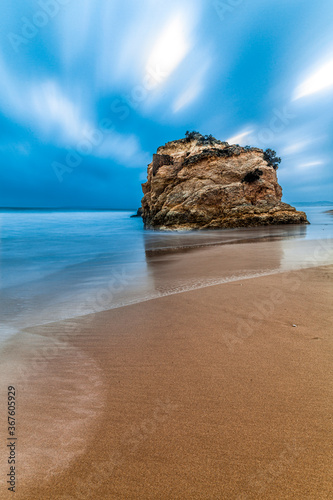 Loney Rock on portuges beach, Praia Dos Tres Irmaos, Portugal. photo