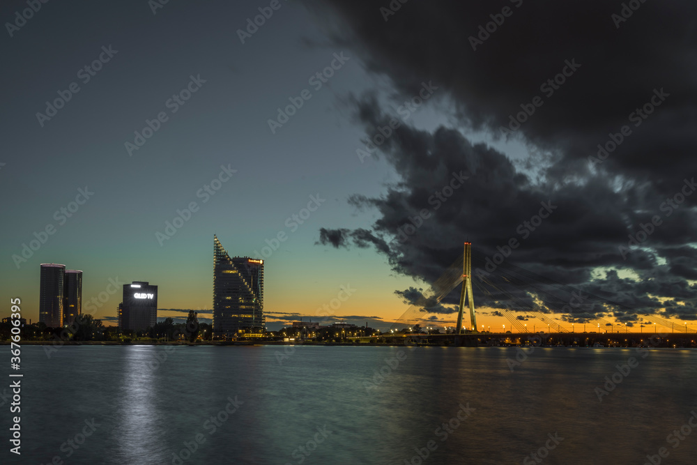Fototapeta premium Cable stayed bridge across Daugava river at night in Riga, Latvia.