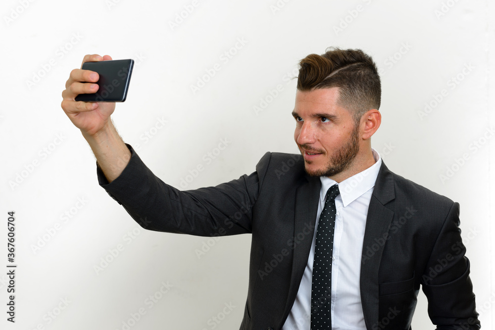 Portrait of handsome bearded Hispanic businessman in suit Portrait of handsome bearded Hispanic businessman in suit