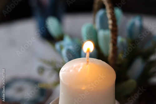 The candle is lit on a dark background.
