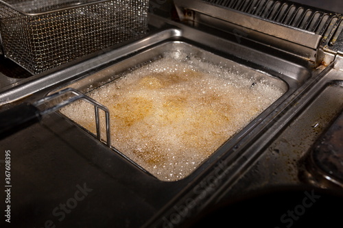 Boiling oil in a container for someanes of fries