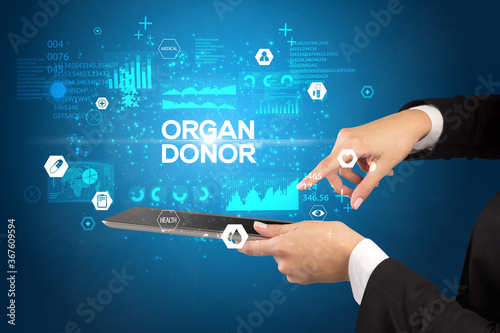 Close-up of a touchscreen with ORGAN DONOR inscription, medical concept