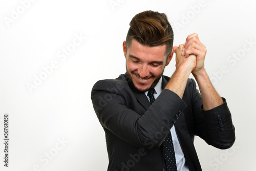 Portrait of handsome bearded Hispanic businessman in suit