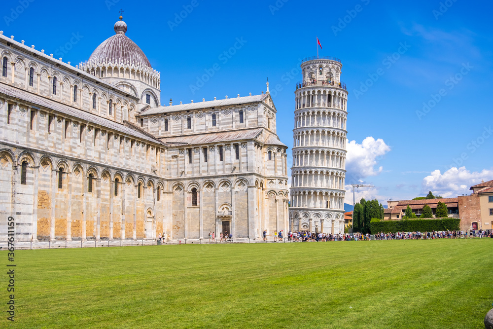 Pisa, Italy - August 14, 2019: View of the Pisa Cathedral with the Leaning Tower of Pisa in Piazza dei Miracoli of Pisa, region of Tuscany, Italy