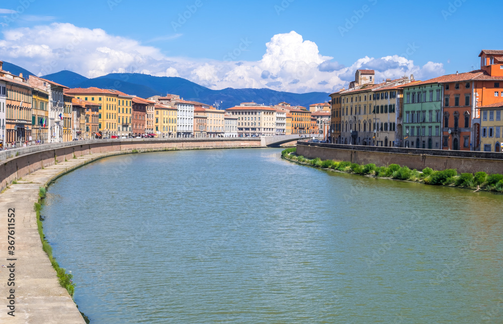 Pisa, Italy - August 14, 2019: Colorful houses at the Arno river waterfront in the historic centre of Pisa city in Tuscany, Italy