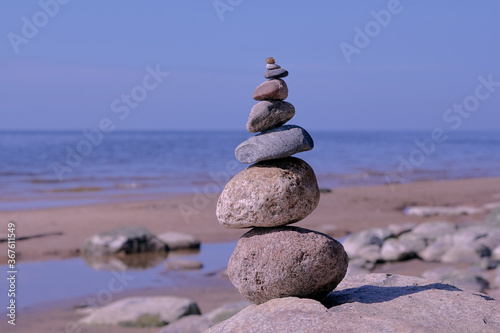 Stone pyramid of rounded stones by the sea