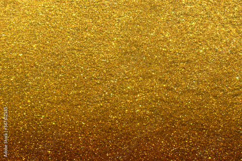 Luxury gold glitter texture with bright sparkles and flickers on the white isolated background. Shiny glamour background