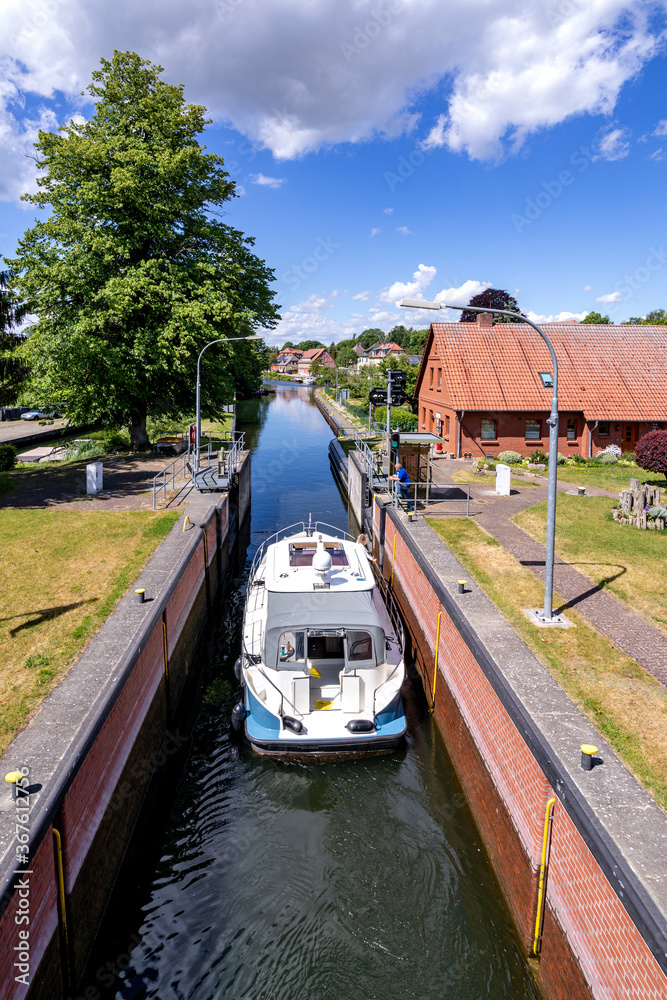 Naklejka premium motorboat in the river Elde lock in Plau am See, Germany