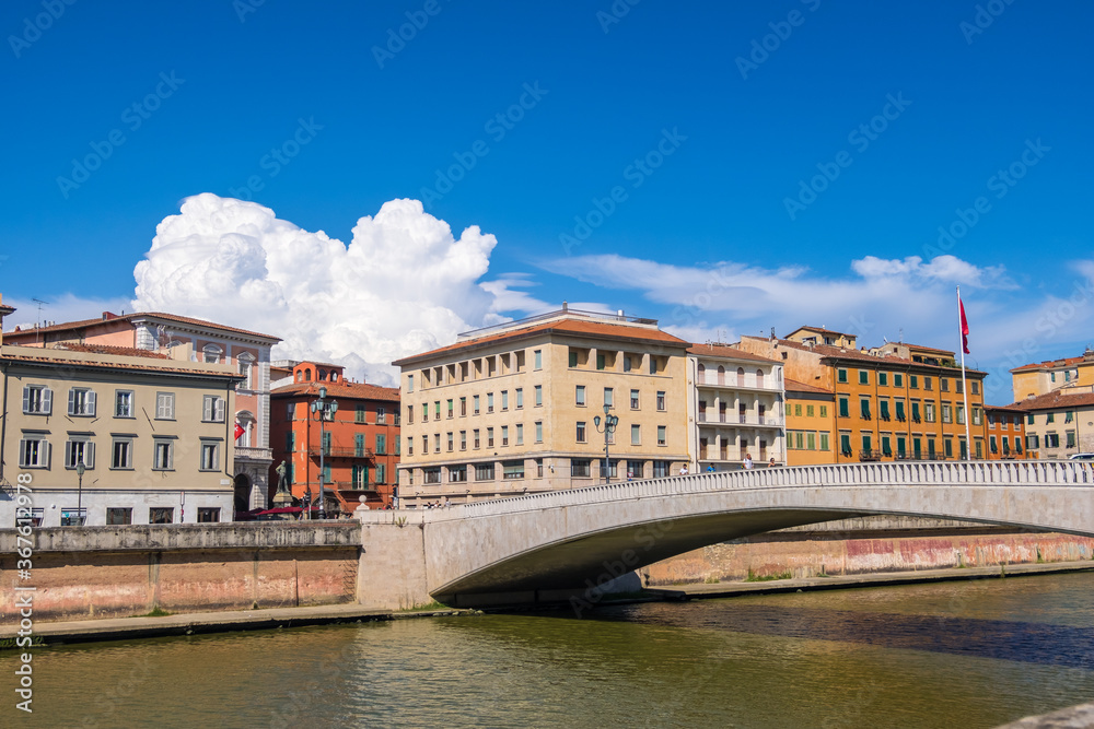 Pisa, Italy - August 14, 2019: The Ponte di mezzo or Middle bridge and Piazza Garibaldi with statue of Giuseppe Garibaldi in Pisa, region of Tuscany