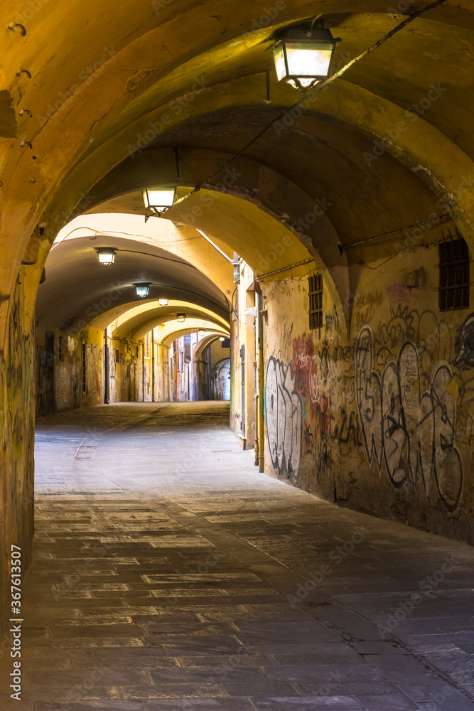 Pisa, Italy - August 14, 2019: Passages under the houses to get to other houses in the old town of Pisa, Tuscany, Italy