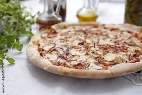 Pizza with tuna, onion, capers, and mozzarella cheese. Italian cuisine.
Traditional Italian pizza. Suggestion to serve a dish. Food background.