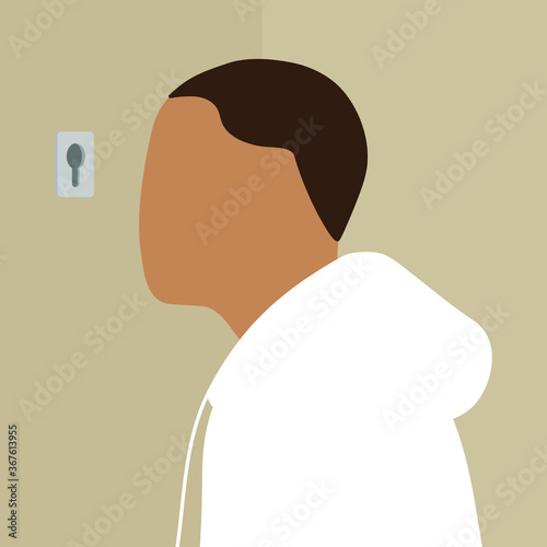 A man looks through a keyhole