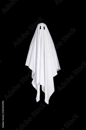 White ghost with black eyes, made from a bedsheet. Isolated on black background. photo