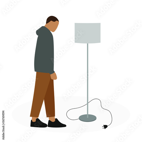 Male character looks at a turned off floor lamp with a cord and plug