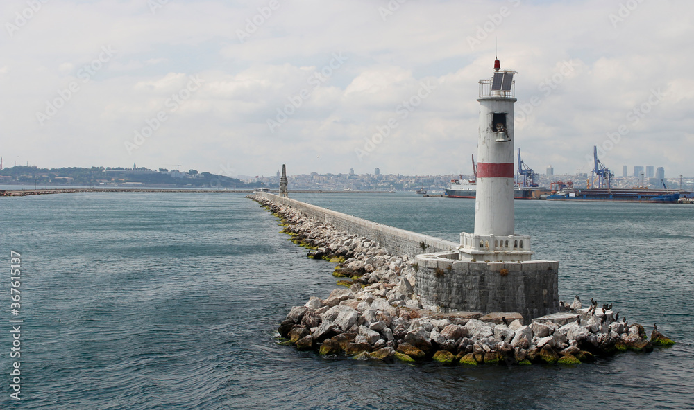 Lighthouse in the Bosphorus. Breakwater in the Bosphorus. Mossy cliffs