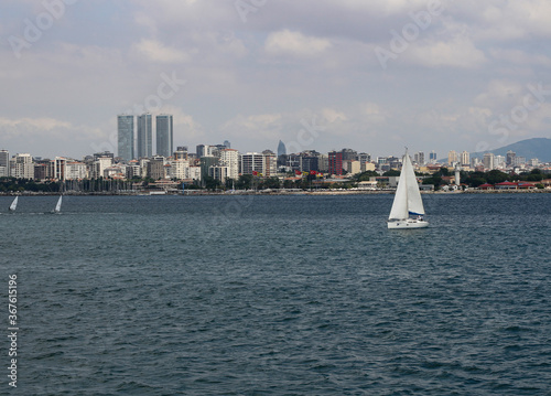 Istanbul Anatolian side view. White sailboats. Istanbul Moda shore.