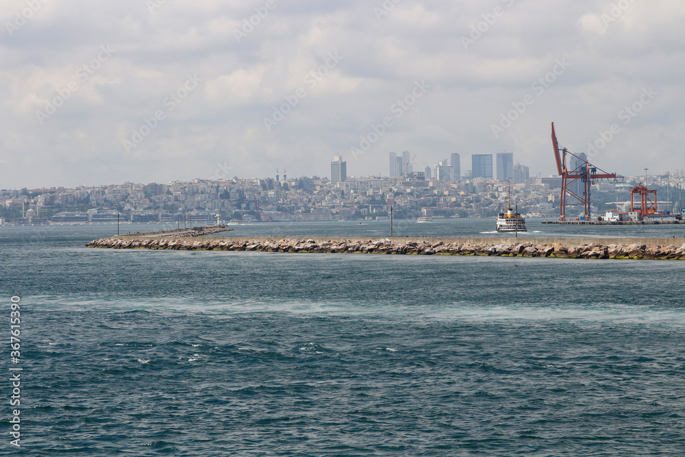 Breakwater in the Bosphorus. Istanbul city silhouette.