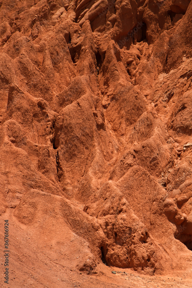 Geology. Natural texture. Closeup of the red and orange rock formation in the desert mountain. 