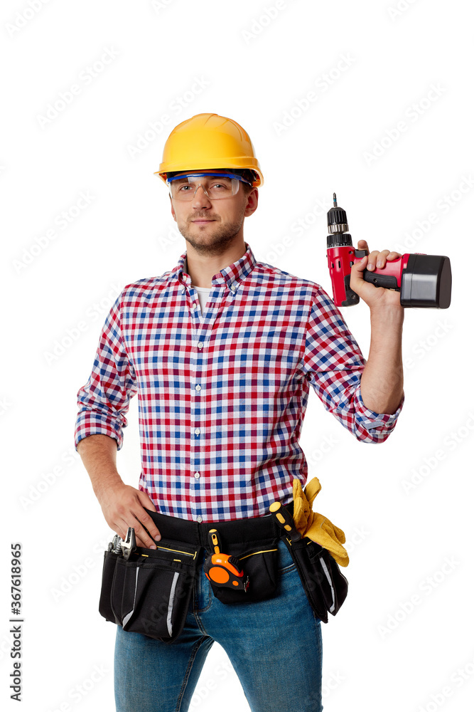 caucasian repairman worker in yellow hard hat holding cordless screwdriver. handyman wearing tool belt isolated on white studio background caucasian repairman worker in yellow hard hat holding cordless screwdriver. handyman wearing tool belt isolated on white studio background