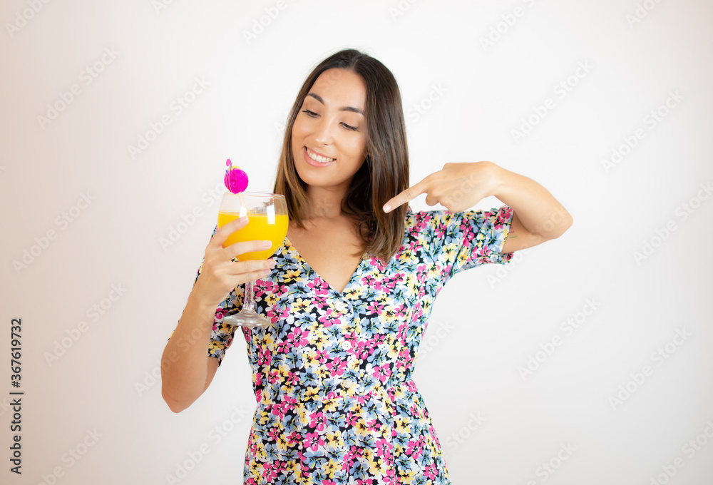 Pretty woman in colorful dress with a cocktail Pretty woman in colorful dress with a cocktail