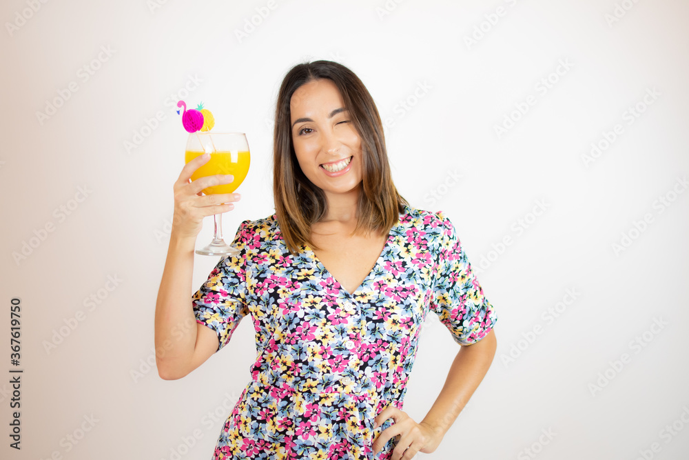 Pretty woman in colorful dress with a cocktail Pretty woman in colorful dress with a cocktail