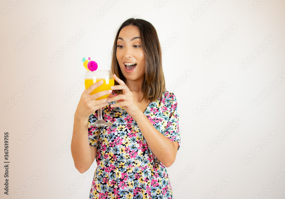 Pretty woman in colorful dress with a cocktail Pretty woman in colorful dress with a cocktail