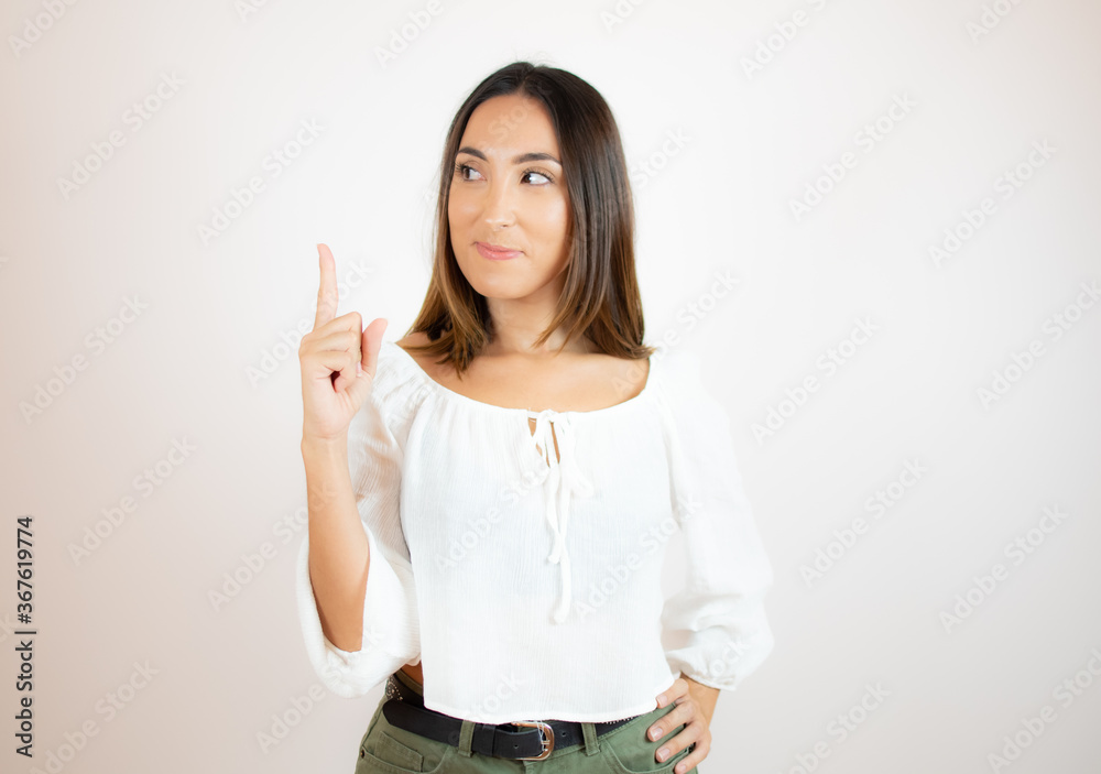 Beautiful young woman in white shirt gesturing Beautiful young woman in white shirt gesturing