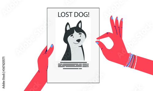 Hands holding a poster with a photo of a lost dog. Missing poster.