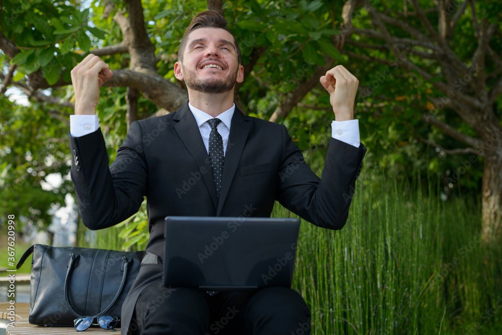 Handsome bearded Hispanic businessman with nature in the city outdoors Handsome bearded Hispanic businessman with nature in the city outdoors