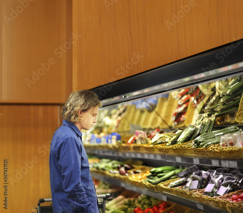 Supermarket shopping, man buying vegetables at the market