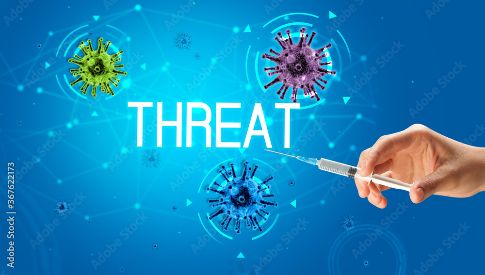 Syringe, medical injection in hand with THREAT inscription, coronavirus vaccine concept Syringe, medical injection in hand with THREAT inscription, coronavirus vaccine concept