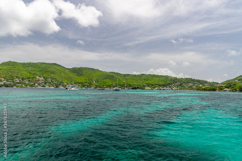 Turquoise water in Admiralty Bay with sailboats and hills in the background, Bequia, Saint Vincent and the Grenadines