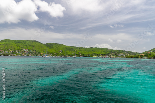 Turquoise water in Admiralty Bay with sailboats and hills in the background, Bequia, Saint Vincent and the Grenadines