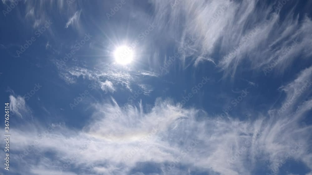 timelapse, white clouds on a blue sky. Unrealistic rapid movement of white clouds in the blue sky. movement of clouds filling the space. the bright sun in the blue sky creates rays. timelapse, white clouds on a blue sky. Unrealistic rapid movement of white clouds in the blue sky. movement of clouds filling the space. the bright sun in the blue sky creates rays.