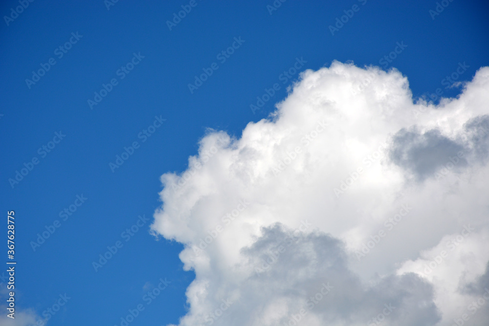 Edge of a beautiful white cloud on a blue sky, horizontal photo. Edge of a beautiful white cloud on a blue sky, horizontal photo.