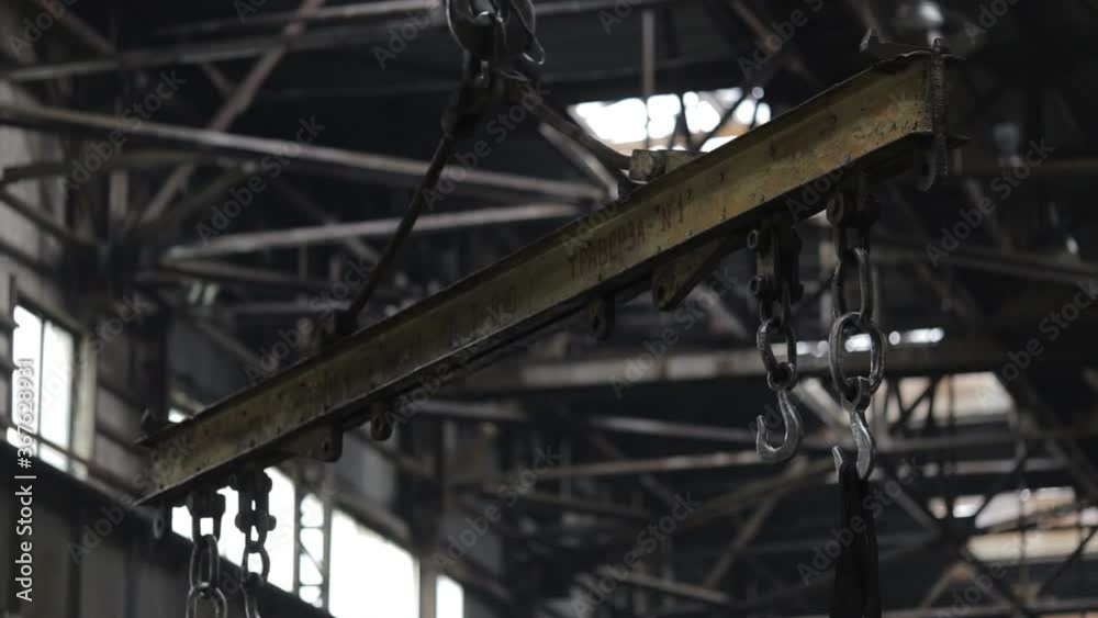 Metallurgical industry. Warehouses of finished products. An industrial crane carries pipes. Metallurgical industry. Warehouses of finished products. An industrial crane carries pipes.