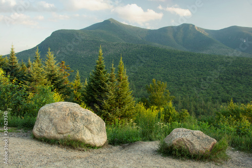 Kancamagus Highway, White Mountain National Forest, New Hampshire. Scenic vista of lush forest, evergreen trees, and tall peaks along ridge of rugged Mount Osceola. photo