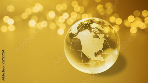 Fototapeta Naklejka Na Ścianę i Meble -  Business USA and Canada on golden economy globe earth ball with abstract golden light chains background new year 2025 america.