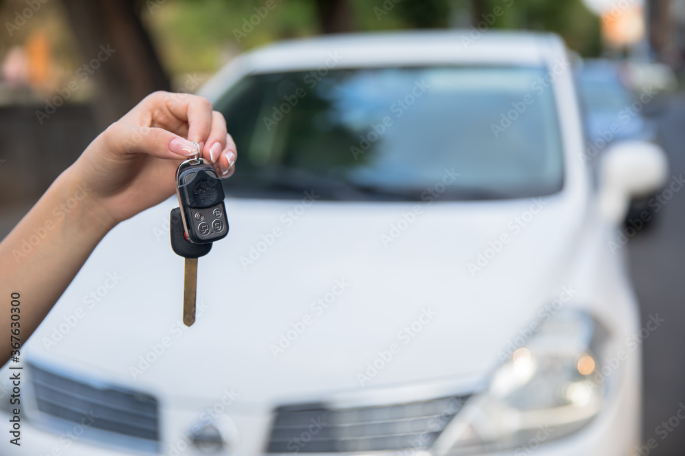 woman hand key and car