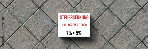 information about the temporary German VAT reduction in 2020 from 7% to 5% on a lightbox in front of stone background