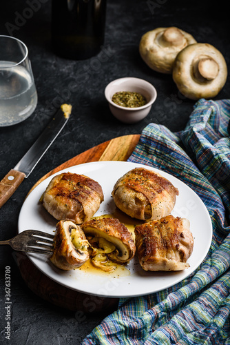 Bacon-wrapped button mushrooms stuffed with grated cheddar cheese and spices