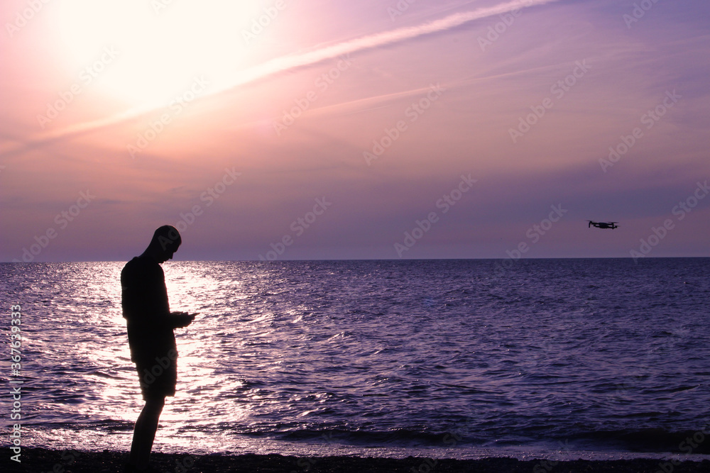 Silhouette of a man along the sunset beach