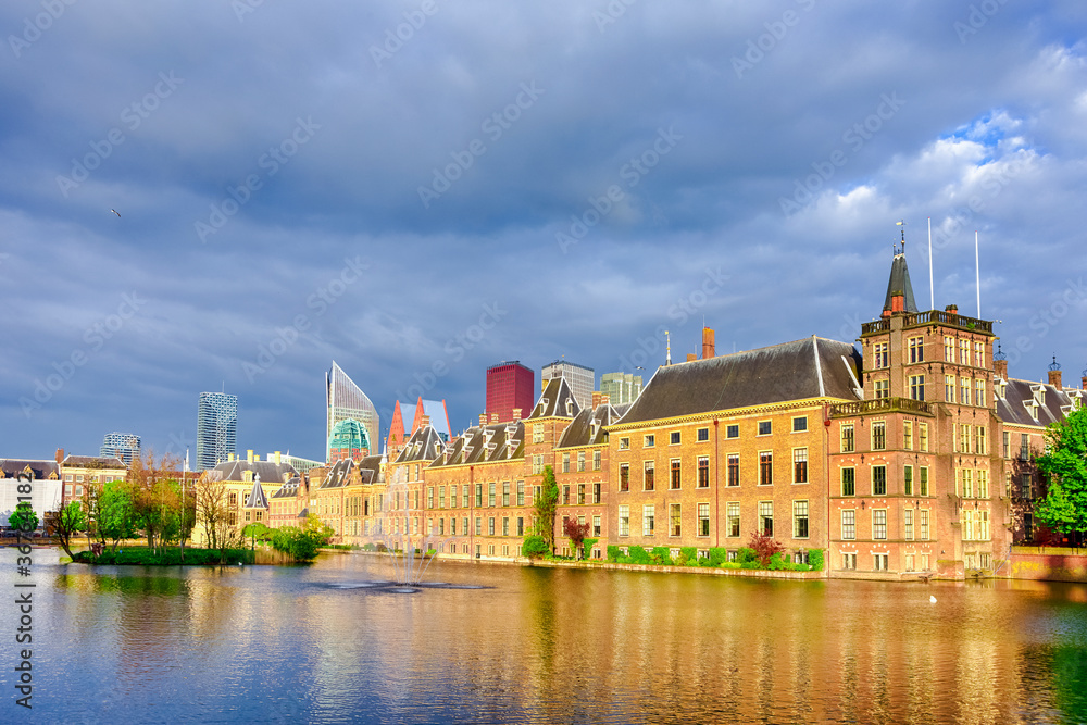Binnenhof Palace of Parliament inThe Hague in The Netherlands At Daytime. Against Modern Skyscrapers on Background. Binnenhof Palace of Parliament inThe Hague in The Netherlands At Daytime. Against Modern Skyscrapers on Background.
