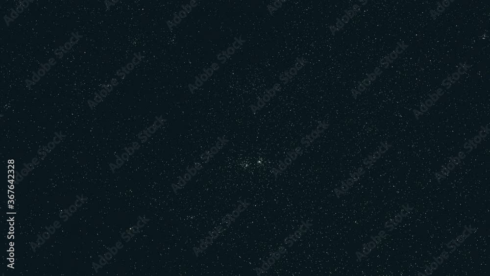 The falling meteors on the shimmering starry sky background. hyper lapse
