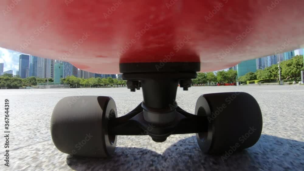 People riding skateboard on street at shenzhen city ,Under skateboard  POV - People skateboarding on road point of view with sound