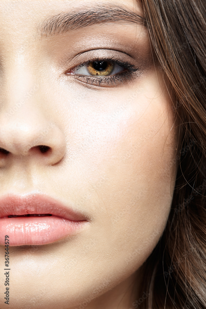 Fototapeta premium Closeup macro portrait of female face with pink lips and smoky eyes beauty makeup.