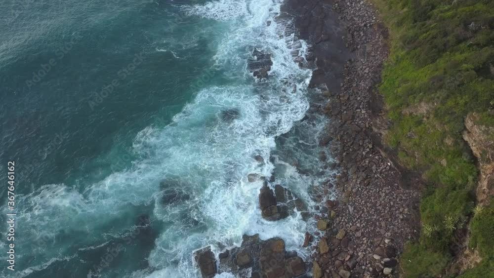 Aerial view of rocky coastline with wave coming in. Aerial view of rocky coastline with wave coming in.